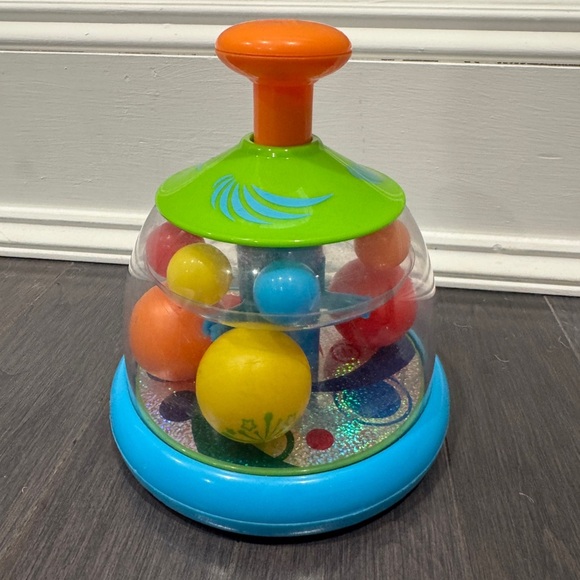 Orange and Green Press and Spin Learning Baby Toy - Picture 1 of 6